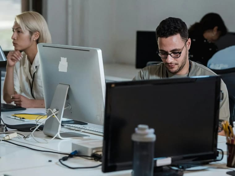 Business software in use on screens at a desk