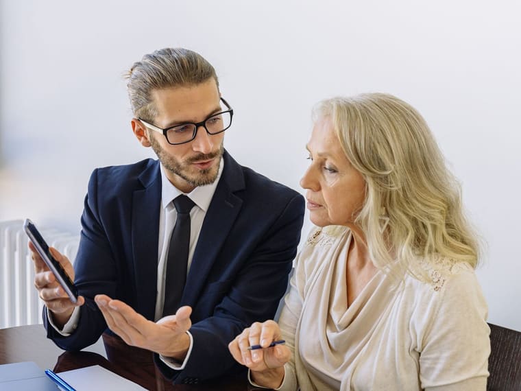 A financial adviser reviewing documents with a client